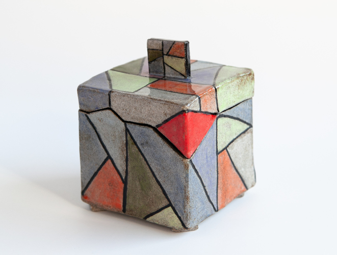 Multicoloured box with black interior and edging.