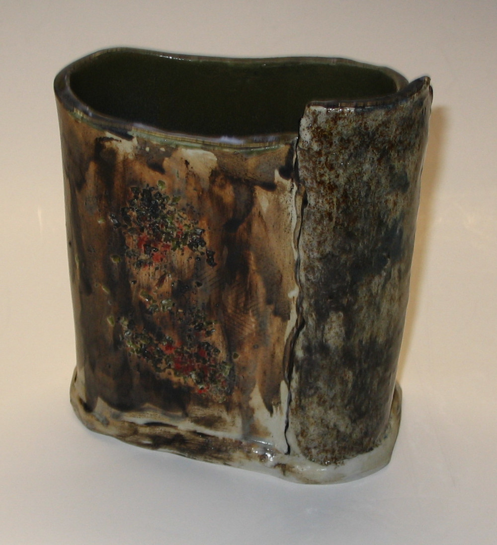 'Embers' - Oval shaped vessel with brown and black underglaze. Dots of red to represent embers. Black glazed interior.