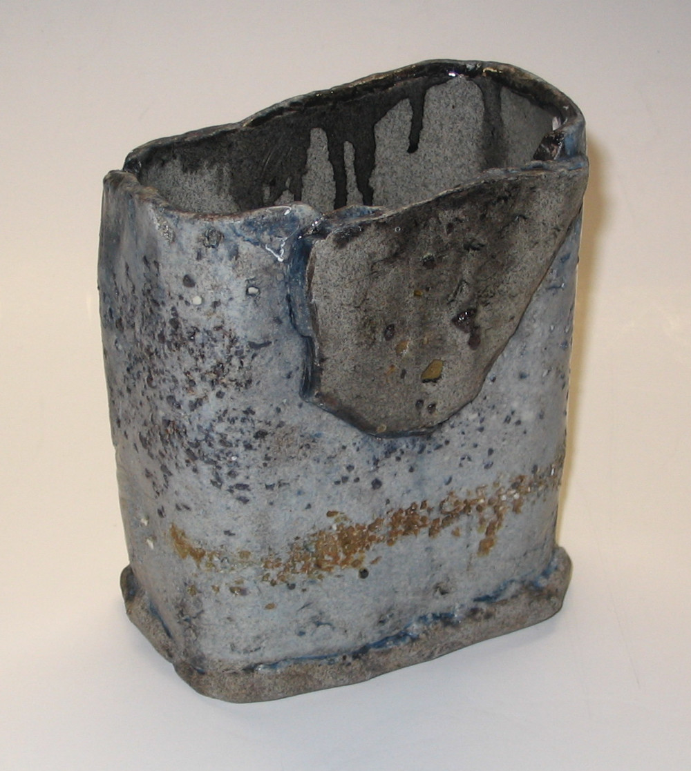 'Beach' - Oval shaped vessel with texture and grey clay added in top center. Various glazes and underglazes.