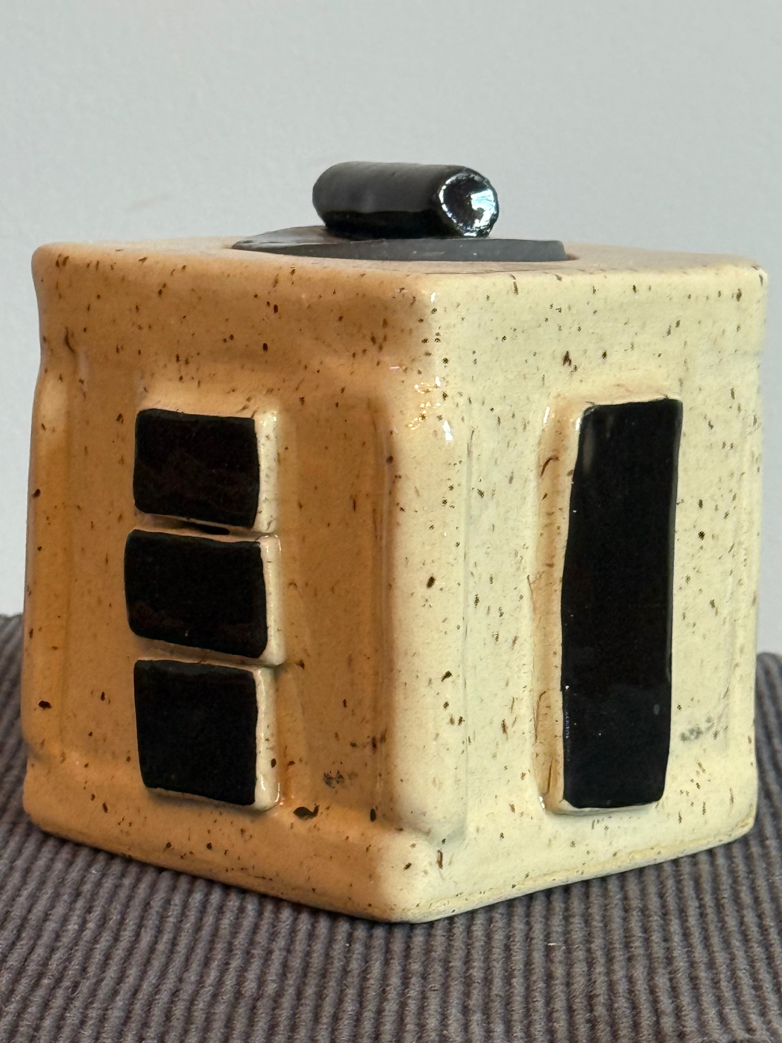 Box done with speckled clay scraps, black accents, round lid and clear glazed