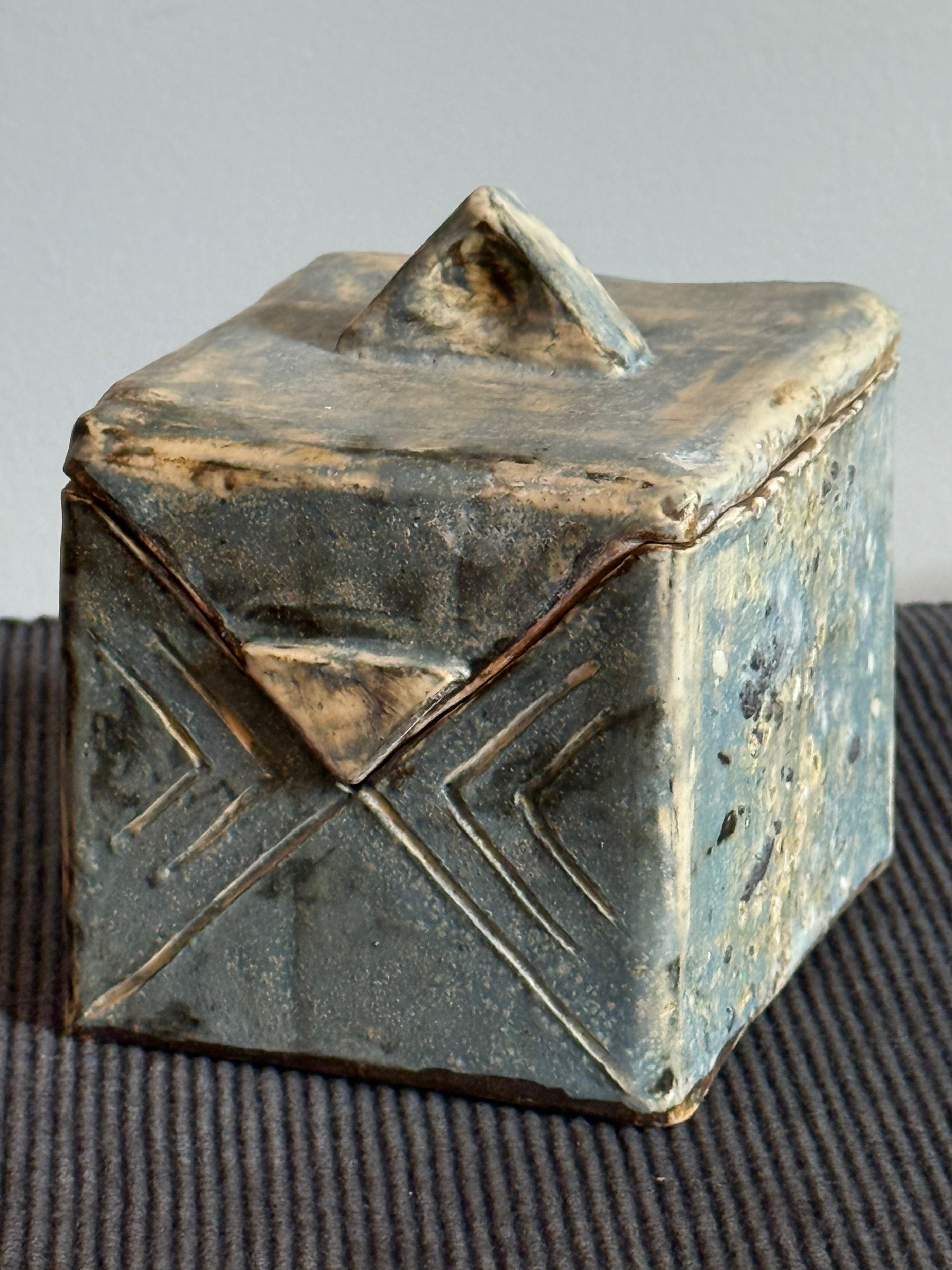 Patterned box in white clay, with triangular lid. Can be decorative or used as container. 14cm H x 14cm W