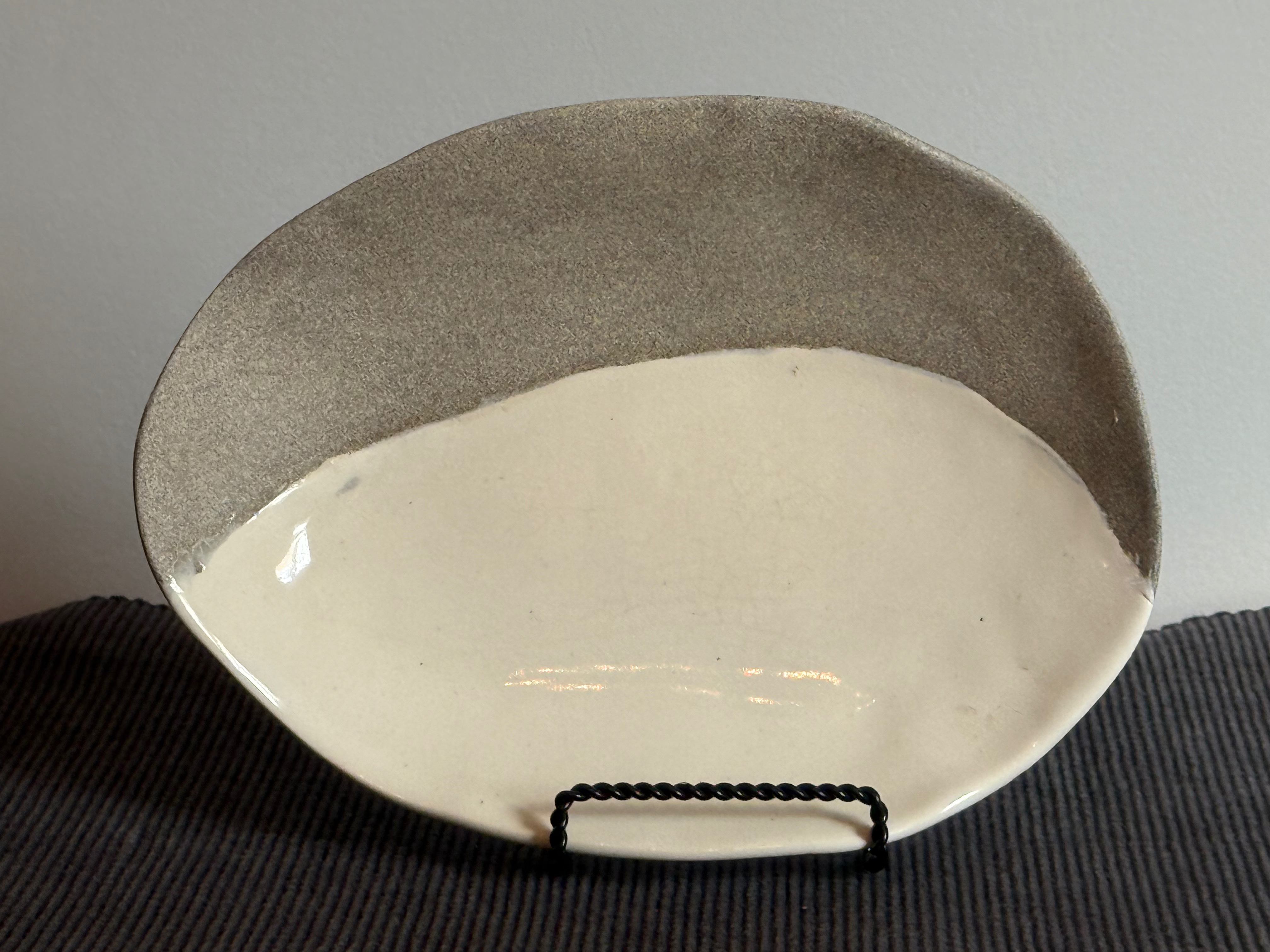 Small platter with granite clay on top and white clay at bottom. Since granite clay shrinks more in firing mode, it was not supposed to be possible for these clays to bind together without cracking or separating.