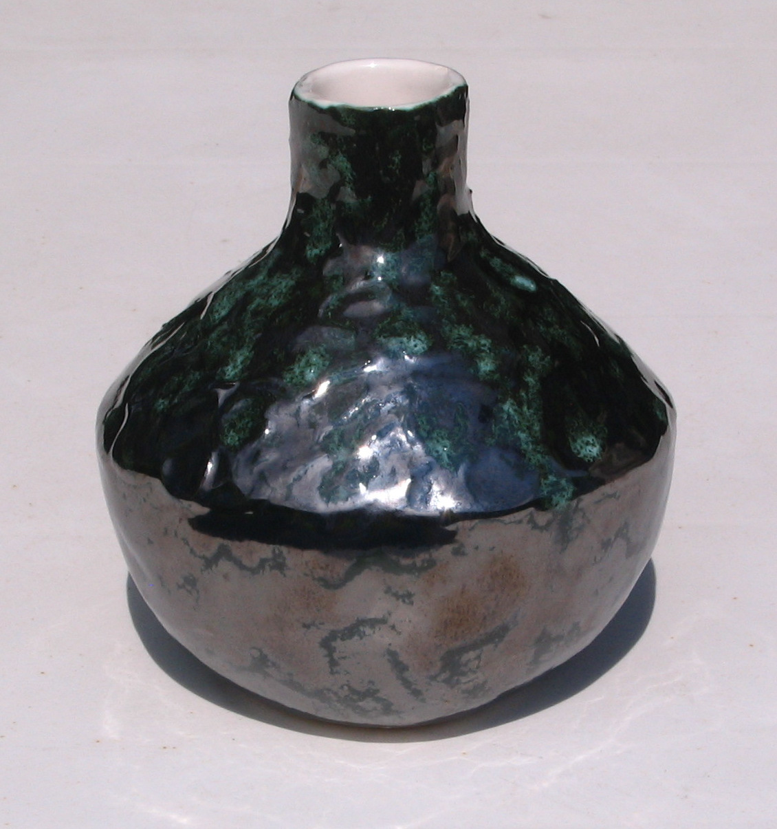 Pewter and white vessel