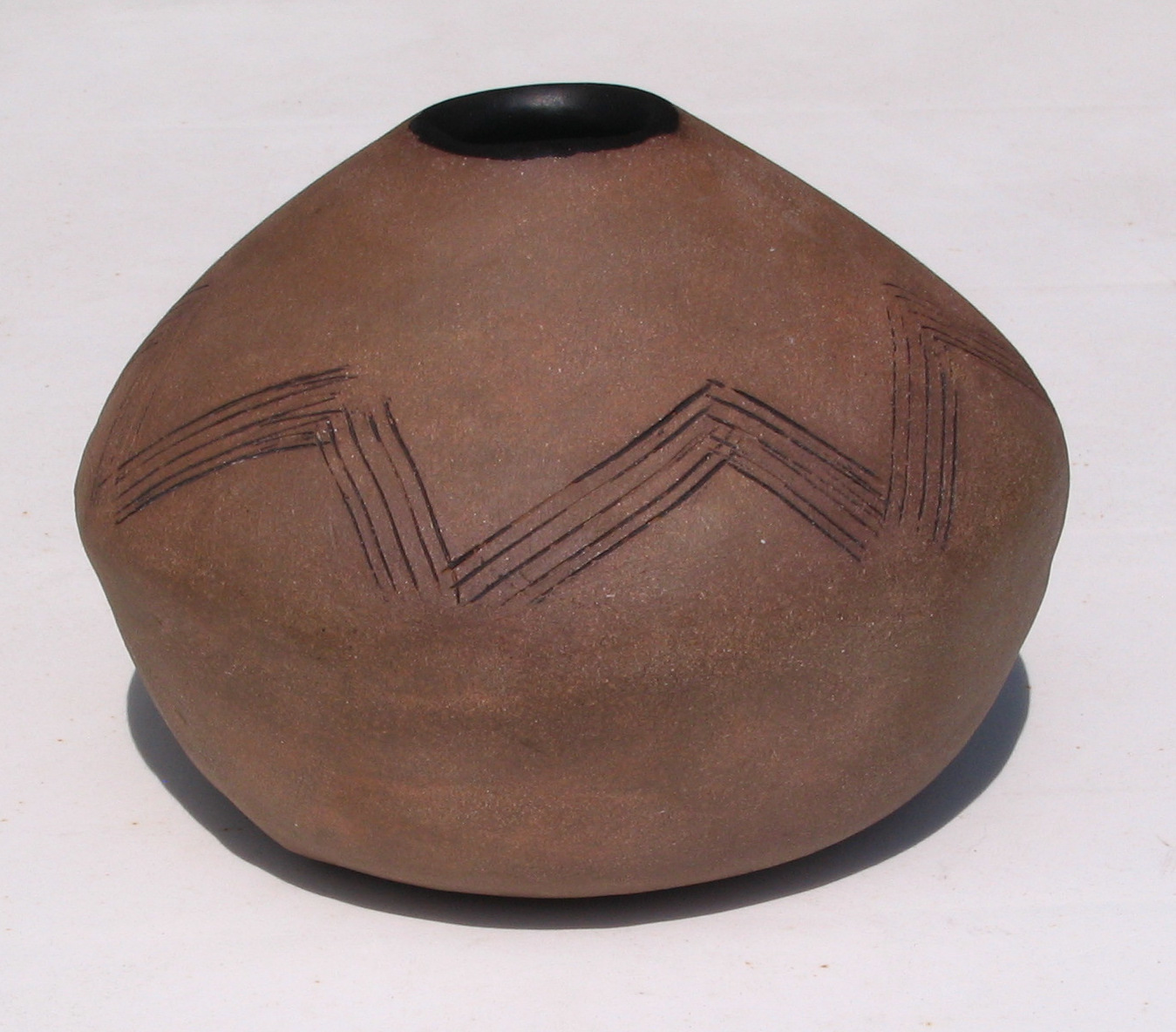 Aztec-like vessel unglazed exterior with matte black interior