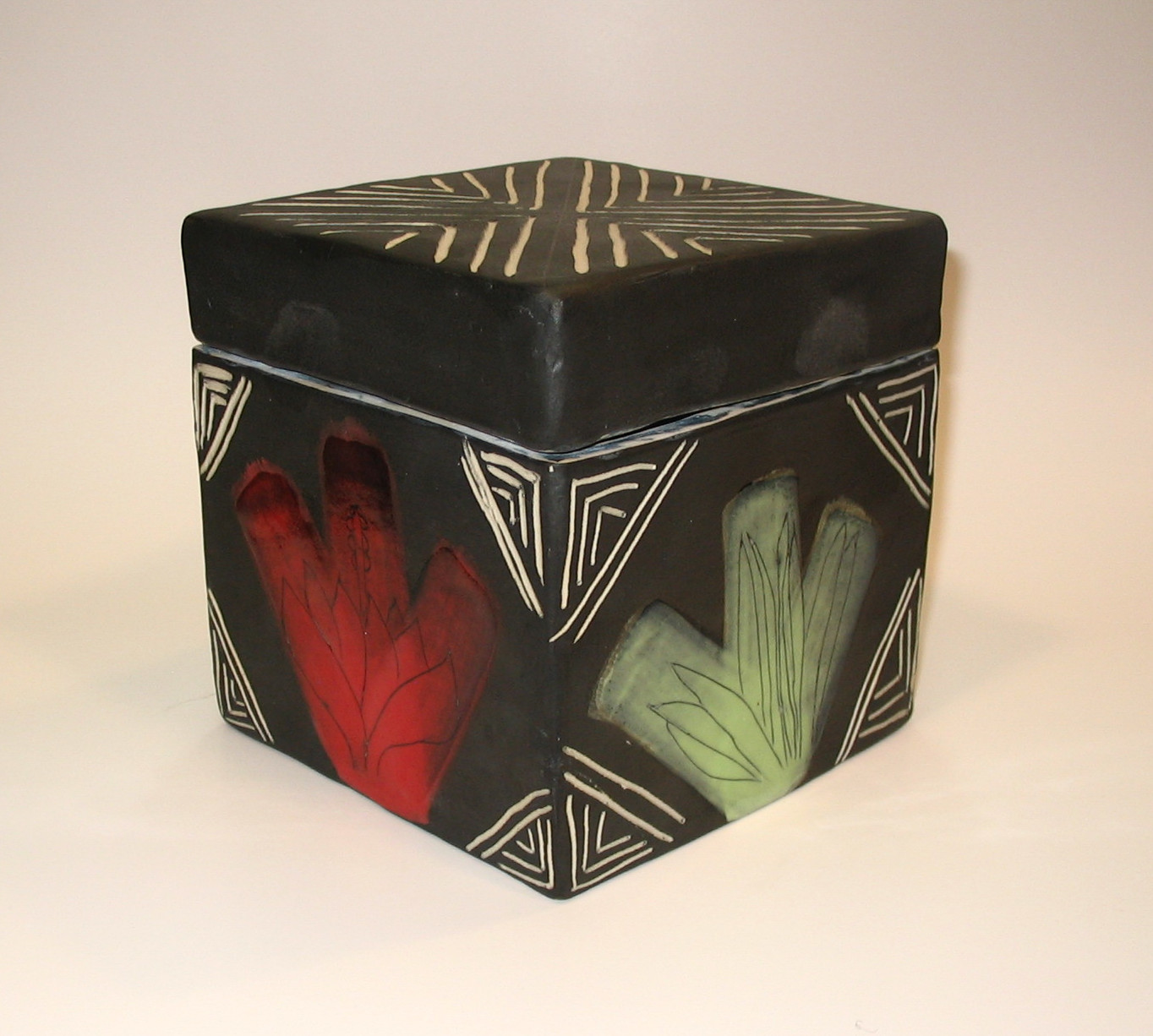 Patterned box in white clay, underglaze, white interior glaze and clear glaze exterior. Can be decorative or used as container. 14cm H x 14cm W