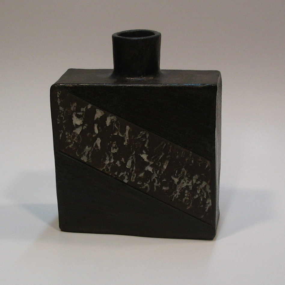 Vessel in black clay with pattern, underglaze and clear glaze. Can be decorative or used as container.