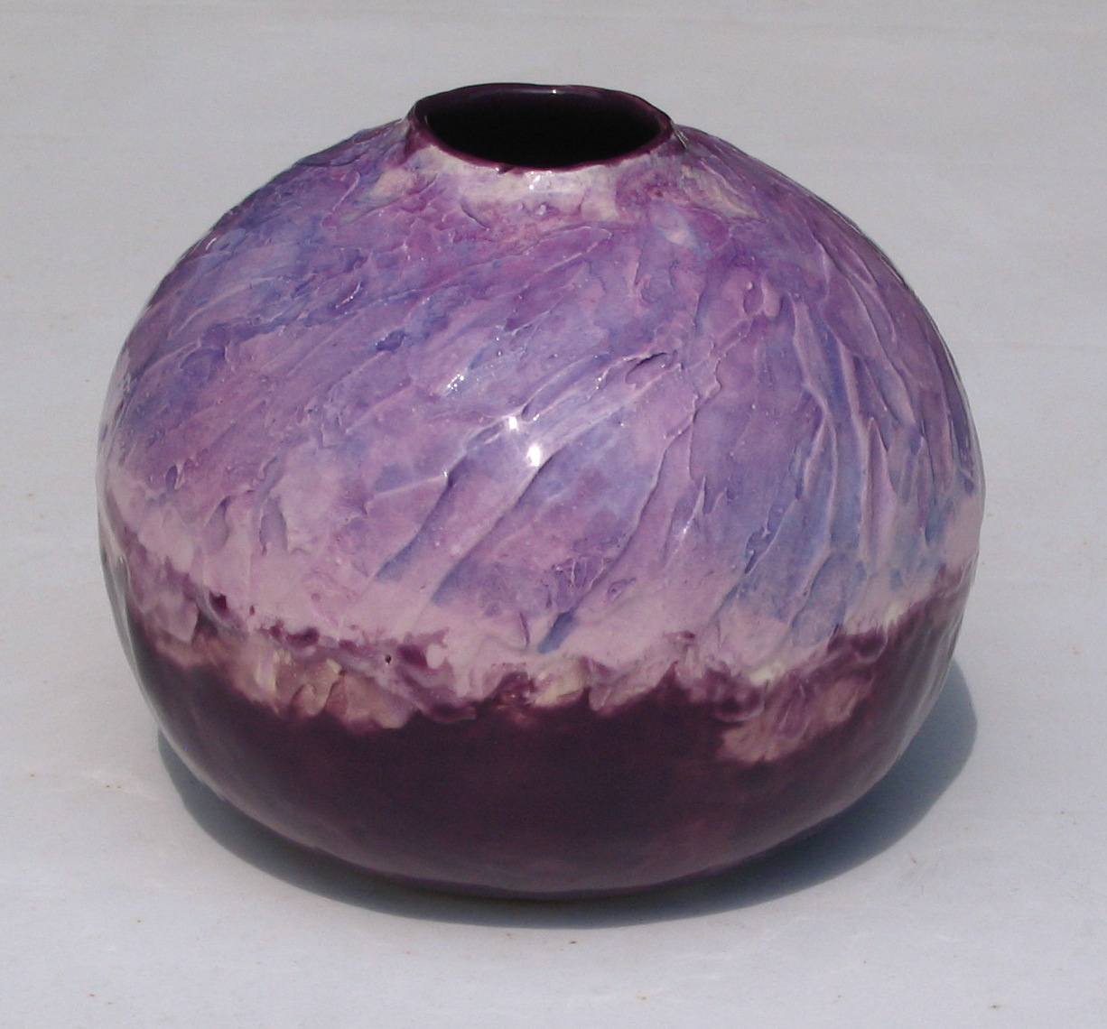 Mix of blue/purple top and purple glaze underneath and interior